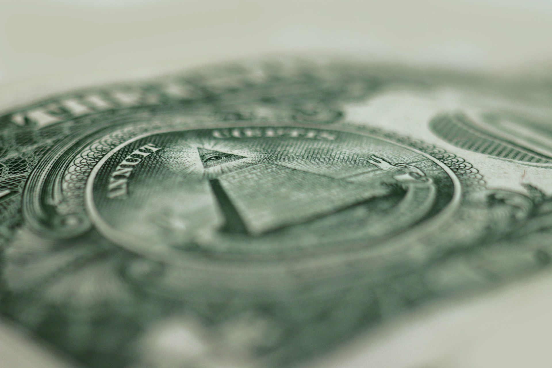 A close-up of the pyramid and all-seeing eye on a one-dollar bill
